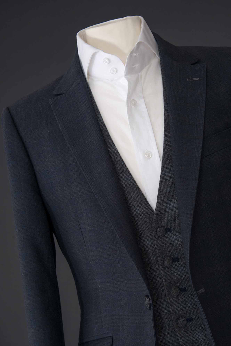 Navy Blue with Grey Windowpane Three Piece Suit with Contrasting Waistcoat. Detailed Contrast on the Lapel Buttonhole and Waistcoat Buttonholes. 100% Cotton Twill Shirt